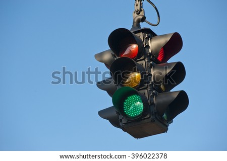 Road street green traffic light with bright blue sky background