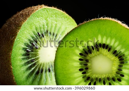 cut of kiwi fruit close-up on black background horizontal format