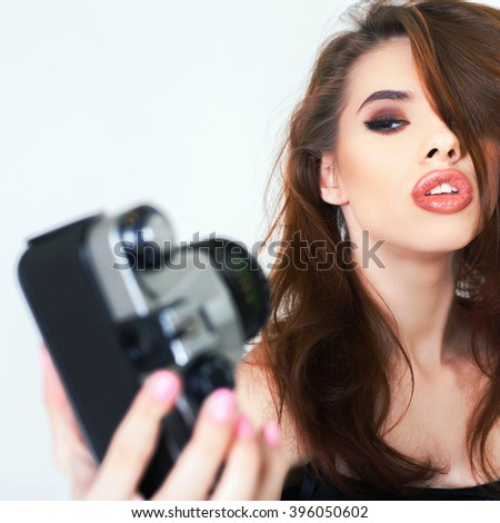 Image of cute girl make a photo selfie at vintage camera. Take a photograph of herself. Funny, party. Beauty. Happy girl smiling. Makeup and hairstyle