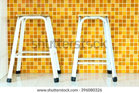 Two Chairs with Orange Mosaic Tiles Background