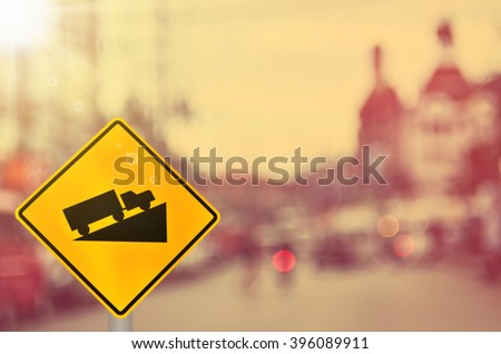 Traffic sign, up hill on blur road background. Retro color style.