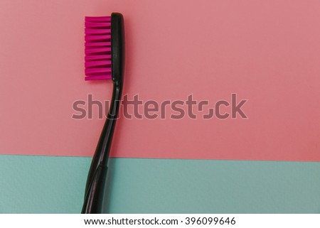 Fashion close up shot of crazy colored toothbrush on pastel background. Minimal flat lay style.  