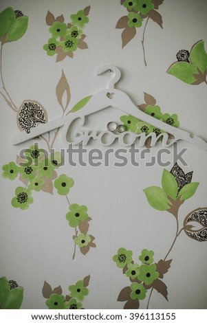 clothes hanger with Groom logo and rings