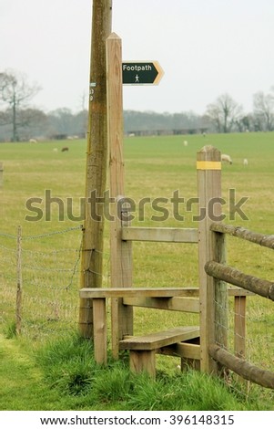 footpath sign and stile into country field stock, photo, photograph, image, picture, 