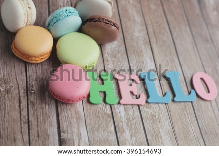 Hello macaroons. hello letters. Say hello. Sweet morning. Shabby wooden background. 
