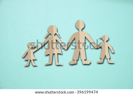 Happy family paper cut on cement wall background
