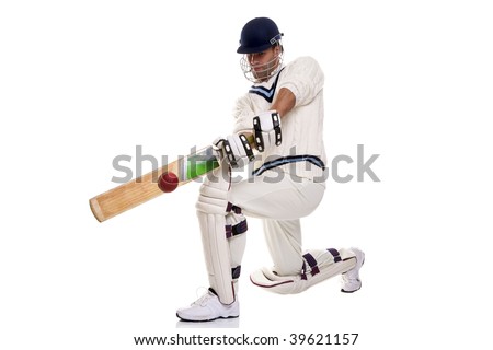 Cricketer down on his knee playing a shot, studio shot on white background.