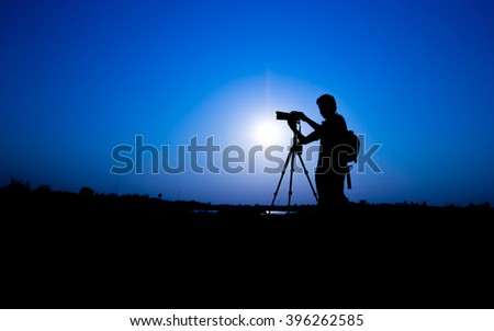 silhouette of photographer on sunrise