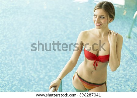 Young woman standing alone in the pool