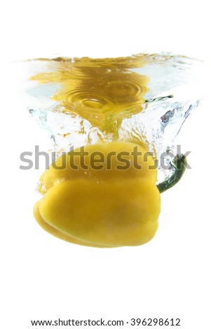yellow pepper on white background falling and splashing water, giving a unique feeling of freshness and vitality