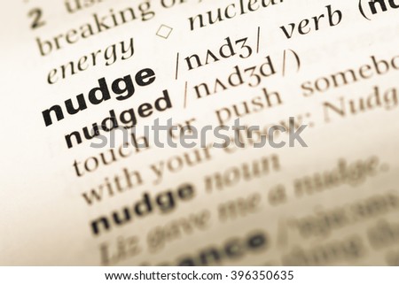 Close up of old English dictionary page with word nudge Royalty-Free Stock Photo #396350635