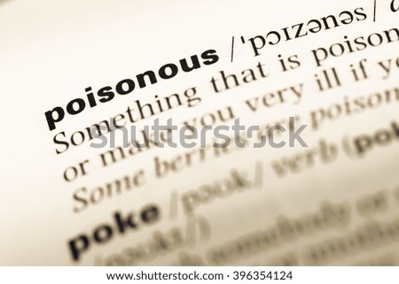 Close up of old English dictionary page with word poisonous