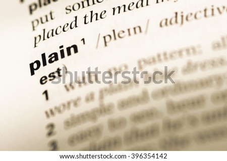 Close up of old English dictionary page with word plain