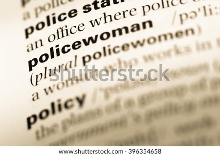 Close up of old English dictionary page with word policewoman
