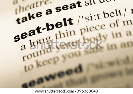 Close up of old English dictionary page with word seat belt