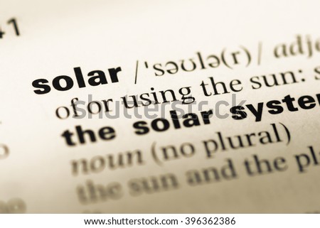 Close up of old English dictionary page with word solar