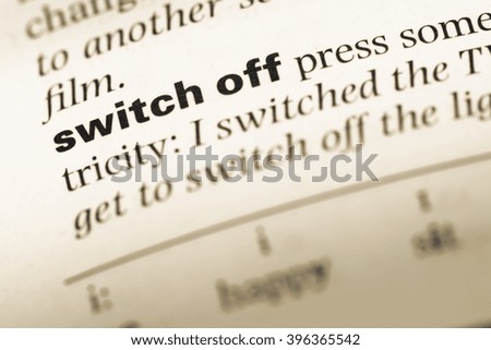 Close up of old English dictionary page with word switch off