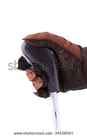 Hand in a leather brown glove on the carbon fiber handle of the switch of drives of speeds on the isolated white background