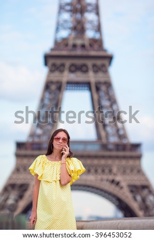 Young woman talking by phone background Eiffel Tower in Paris