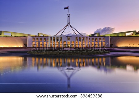 colourful reflection of Canberra's new parliament building in a fountain pond at sunset. Royalty-Free Stock Photo #396459388