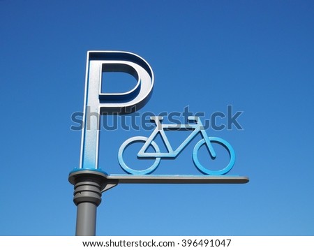 Blue bicycle parking sign on blue sky background.Outdoor bicycle parking.