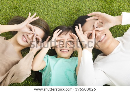 top view of Happy  Young  Family lying on the grass Royalty-Free Stock Photo #396503026