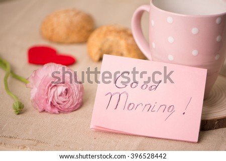 Cup of coffee and cookies on the table. Wishing a nice day.