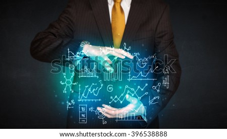 Businessman holding hand drawn business schemes