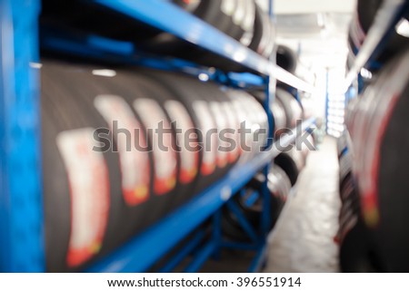Blurred group of new tires for sale at a tire store Royalty-Free Stock Photo #396551914