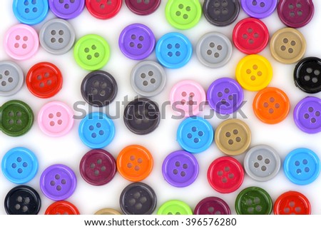 multi-colored plastic buttons on a white background.