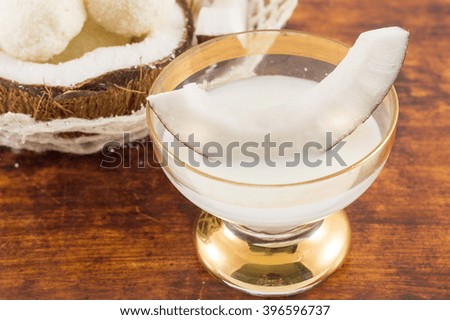 Coconut liqueur in glass served with fresh coconut