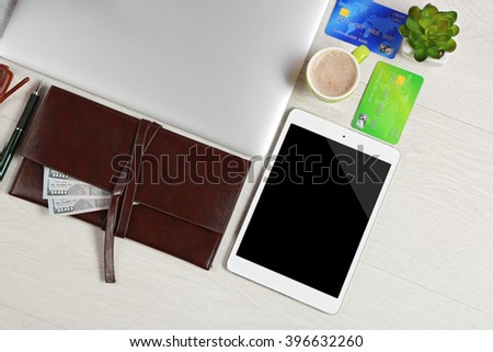 Office supplies and money on a white desk, top view