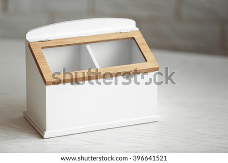 Kitchen box for coffee and sugar with sign on wooden table, closeup