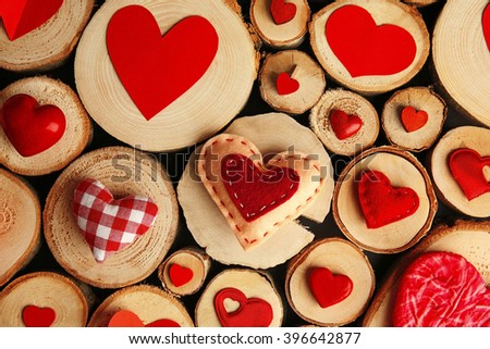 Valentine's Day concept. Different colourful hearts on wooden stumps background