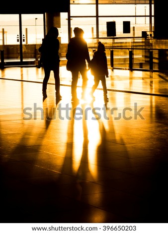 Silhouette family in international airport preparing for departure