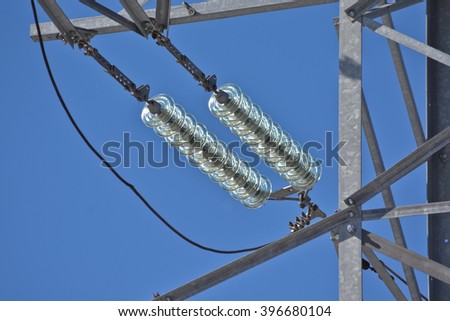 Insulators power lines. Photo of power lines against the blue sky.