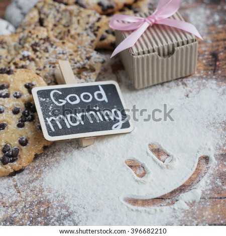 Good morning. Sweet morning box with pink ribbon. Craft box and pink ribbon. Flour smile.  Instagram morning. Sweet flour morning. Good morning chalkboard. Cookies on the wooden background.