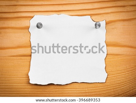 blank sheet of paper on a wooden board