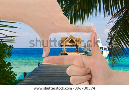 Frame made of hands and beach landscape - vacations background