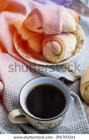 Hot black coffee with abstract background and pastry