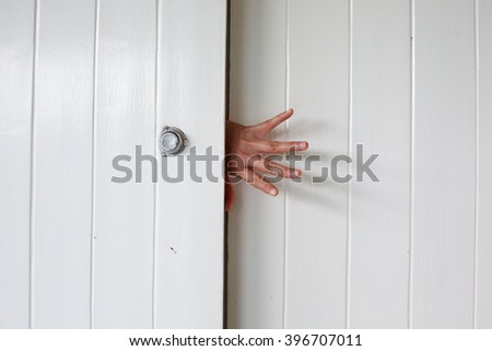 hand on wooden door
