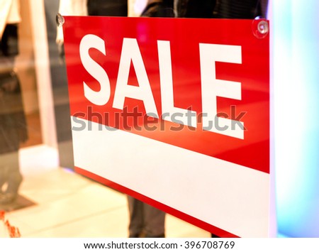 Sale sign with copy space in a shop window. Shopping mall with winter sale. 
