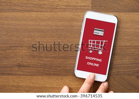 Hand  holding smart phone with shopping on line on screen, omnichannel, business and technology concept
