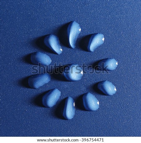 Flower made of water drops on blue background
