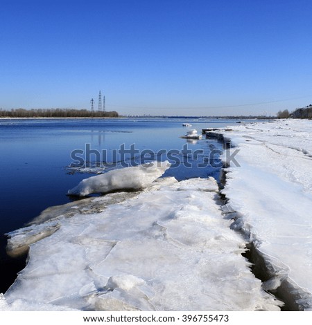 Landscape ice drift on the river in the early spring on a sunny day 