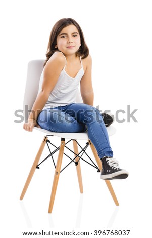 Studio portrait of a beautiful young girl sitting on a chair