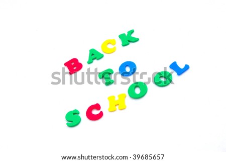 The words BACK TO SCHOOL written with colorful foam letters isolated on white studio background.