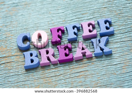Coffee break phrase made of wooden colorful letters on vintage background