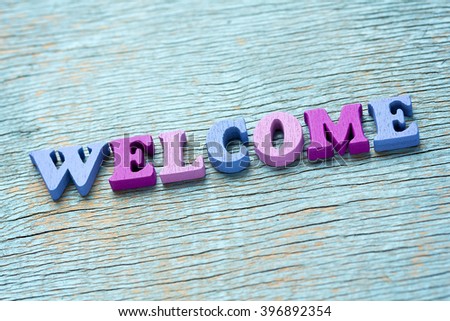 Word welcome made of wooden colorful letters on vintage background