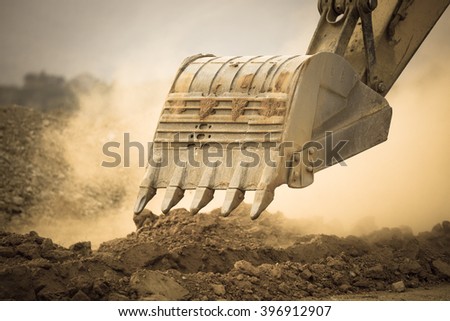 Excavator working with red soil and dusty Royalty-Free Stock Photo #396912907